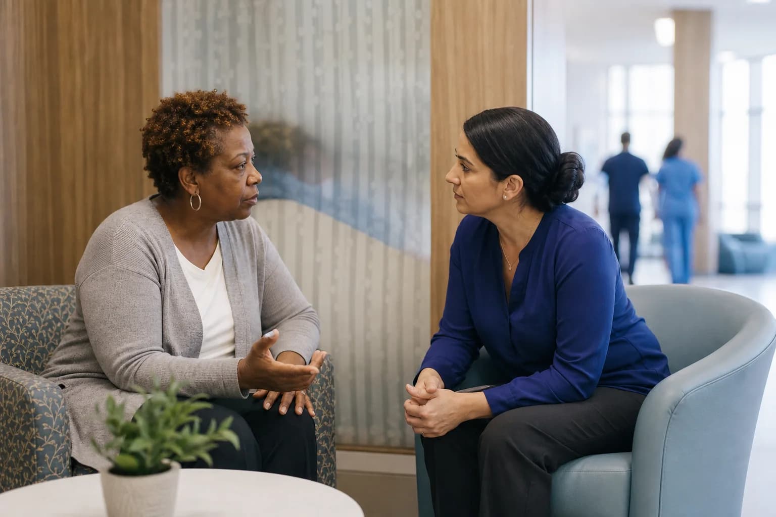 A family member raises a concern with a patient liaison in a private hospital alcove
