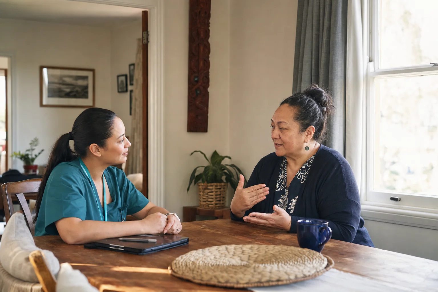 A community nurse listens as a home-care client explains their understanding of a care plan
