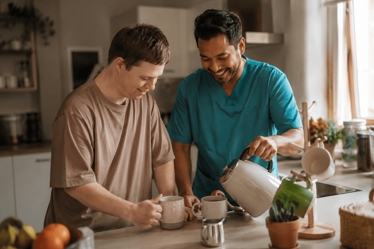A support worker and a client making tea together in a home kitchen
